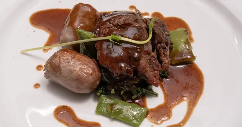 Stock photograph of a carefully plated main course with greens.
